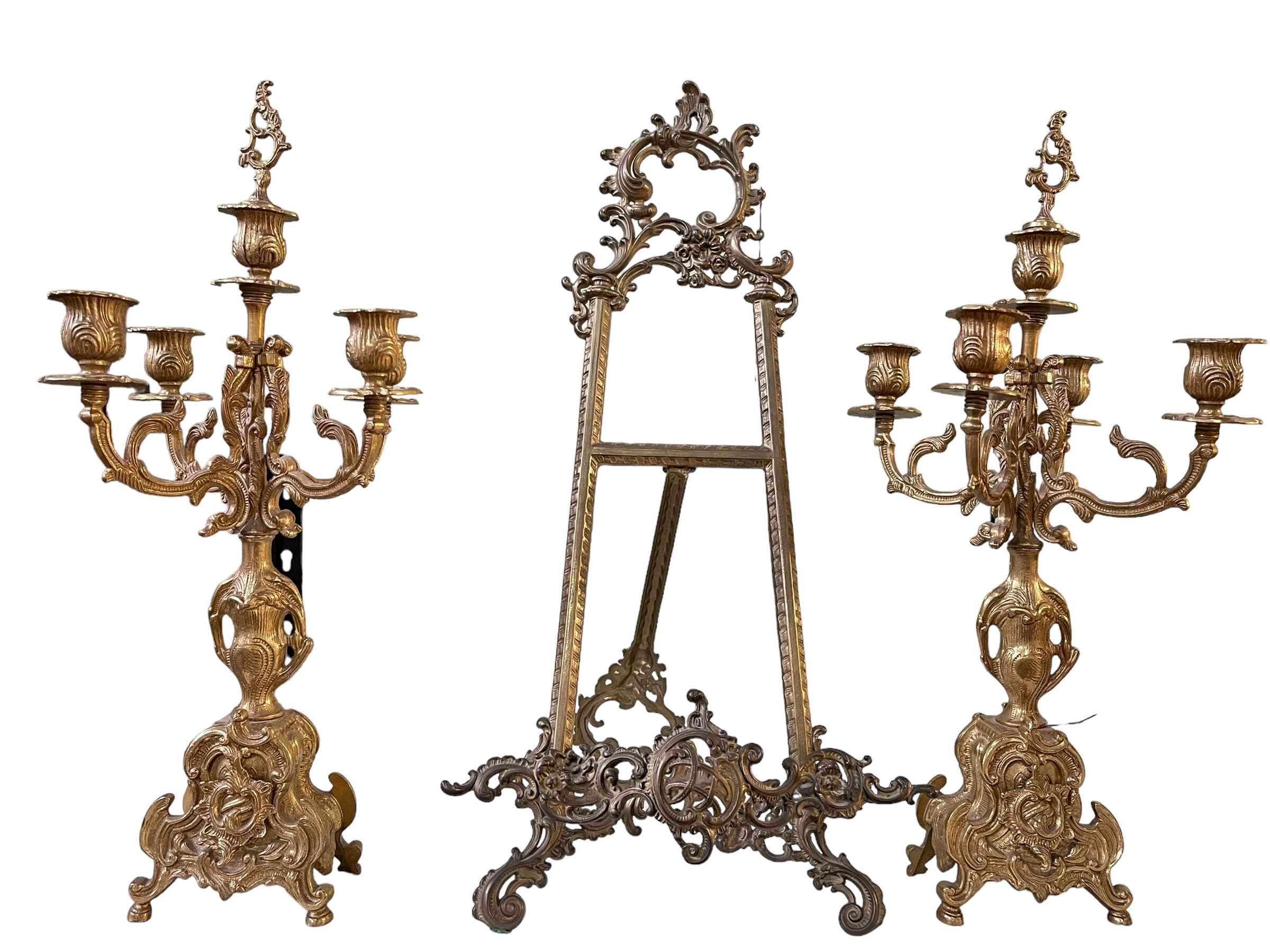 Pair of ornate gilt candelabra and an easel.