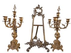 Pair of ornate gilt candelabra and an easel.