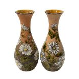 Pair Chr Dresser Linthorpe Pottery vases with glazed flower decoration,