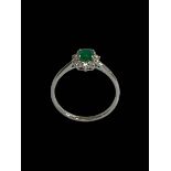 Emerald and diamond cluster ring set in 18 carat white gold, size O.