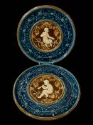 Pair Austrian pottery cherub plates, 30cm diameter.
