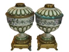 Pair of floral porcelain and gilt metal oil lamp bases, 34cm high.
