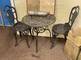 Circular painted aluminium patio table and two chairs.