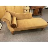 Early 20th Century scroll end chaise longue on oak turned legs.