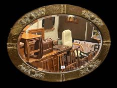 Art Nouveau copper framed oval bevelled wall mirror, 64.5cm by 90cm including frame.