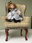 My Best Friend doll seated in a Queen Anne style wing back armchair.