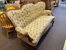 Victorian mahogany framed arched back settee in buttoned floral tapestry fabric.