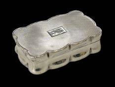 Silver engine-turned snuff box of shaped form, London 1939, 7cm across.