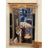 Regency style gilt and black bevelled wall mirror, 126.5cm by 86.5cm.