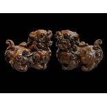 Pair small Chinese boxwood foo dogs with ebony eyes, 6cm length.