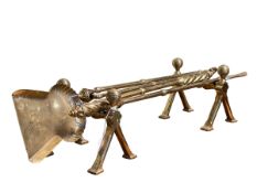 Brass fire irons and dogs.