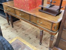 Regency style mahogany three drawer rounded edge side table on six turned tapering reeded legs,