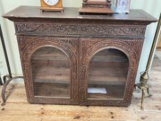 Carved Indian hardwood double arched glazed panel door wall cabinet, 84cm by 106cm by 38cm.