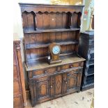 Period style oak dresser, the shelf back above two drawers and two carved arched panel doors,