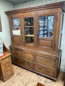 Antique oak press having central glazed panel door flanked by two mirror and fielded panel doors