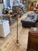 Brass triform floor lamp with Tiffany style shade.