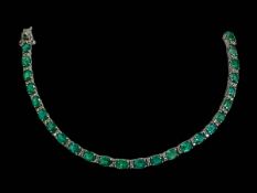 Emerald and diamond bracelet with 25 oval emeralds totalling 9 carats,