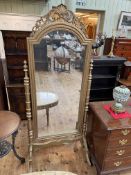 Gilt painted cheval mirror with turned supports, 193cm by 80cm.