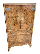 Burr walnut linen cupboard having two doors above three drawers on cabriole legs,