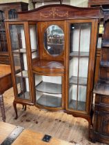 Edwardian inlaid mahogany cabinet having central oval bevelled mirror above a bow glazed door