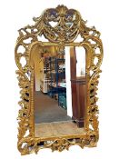 Large ornate gilt framed rectangular wall mirror, 195cm by 115cm.