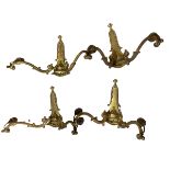 Four ornate brass Art Deco style wall lights.