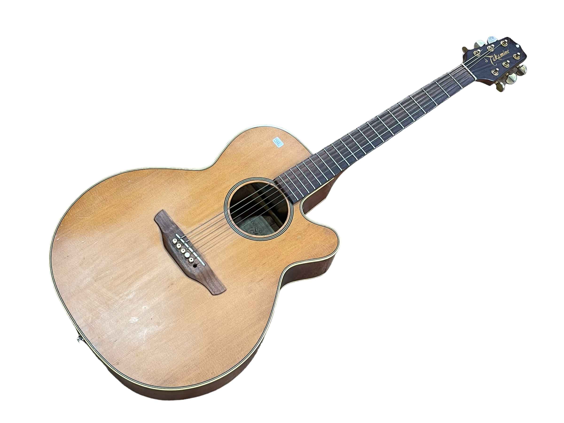 Acoustic guitar with label Takamine.
