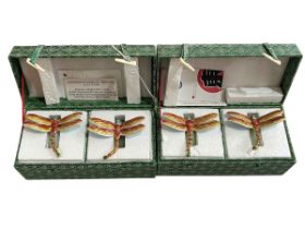 Two boxes with 'Oriental Treasures' jade and enamel napkin rings, four pieces.