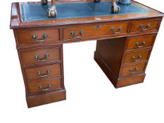 Polished mahogany eight drawer pedestal desk, 75cm by 121cm by 61cm.