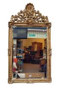 Rectangular gilt framed bevelled wall mirror with shell, garland and fruit crest, 124cm by 66.5cm.