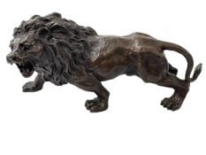 Hollow bronze lion, 30cm length.