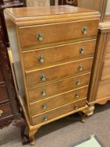 Walnut six drawer chest having one drawer fitted with writing surface, 113cm by 59cm by 45cm.