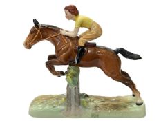 Beswick equestrian taking a fence, yellow top, 25cm.