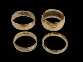 Four 9 carat gold wedding rings.