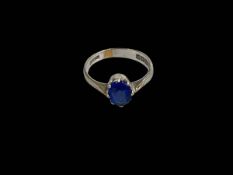 9 carat white gold oval blue stone (sapphire?) ring, size H.