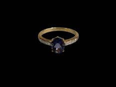 Oval amethyst 9 carat gold ring with diamond set shoulders, size U.