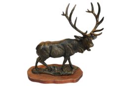 Ornate bronzed stag sculpture on wooden base, 47cm high.