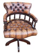 Brown buttoned leather Captains style swivel desk chair.