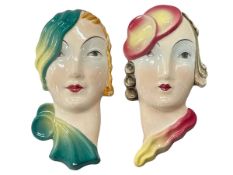 Pair Lorenzl wall masks, impressed numbers 2053.6 and 2015.5, 15cm high.