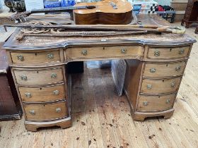 Mahogany double bowfront nine drawer pedestal desk with inverted centre, 77cm by 129cm by 73cm.