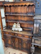 Period style oak dresser, the shelf back above two drawers and two carved arched panel doors,