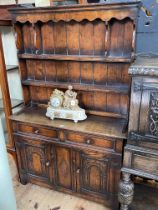 Period style oak dresser, the shelf back above two drawers and two carved arched panel doors,