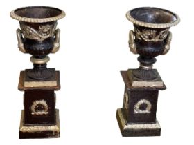 Pair painted cast iron two handled Campana style garden urns on stands, 70cm by 28cm diameter.