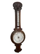 Carved oak aneroid barometer with enamelled dial, 89cm.