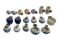 Collection of eighteen Chinese porcelain bird feeders, antique and later.
