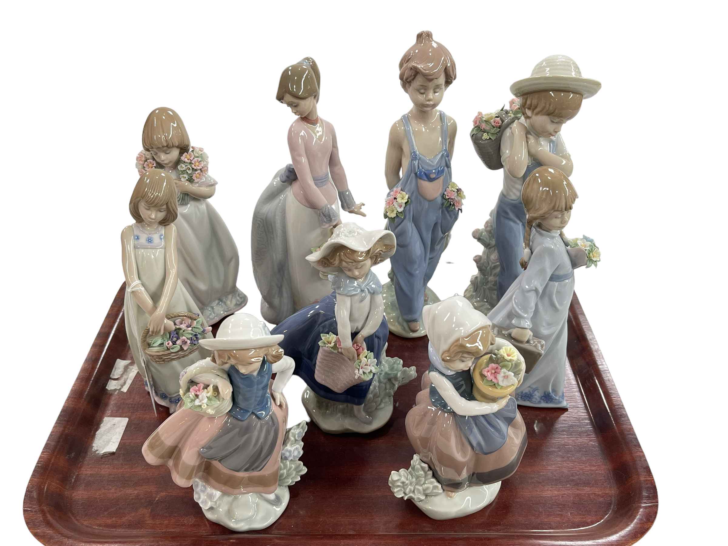 Nine Lladro figures including Spring is Here, School Days, Flower Harvest and Pocket Full of Wishes.