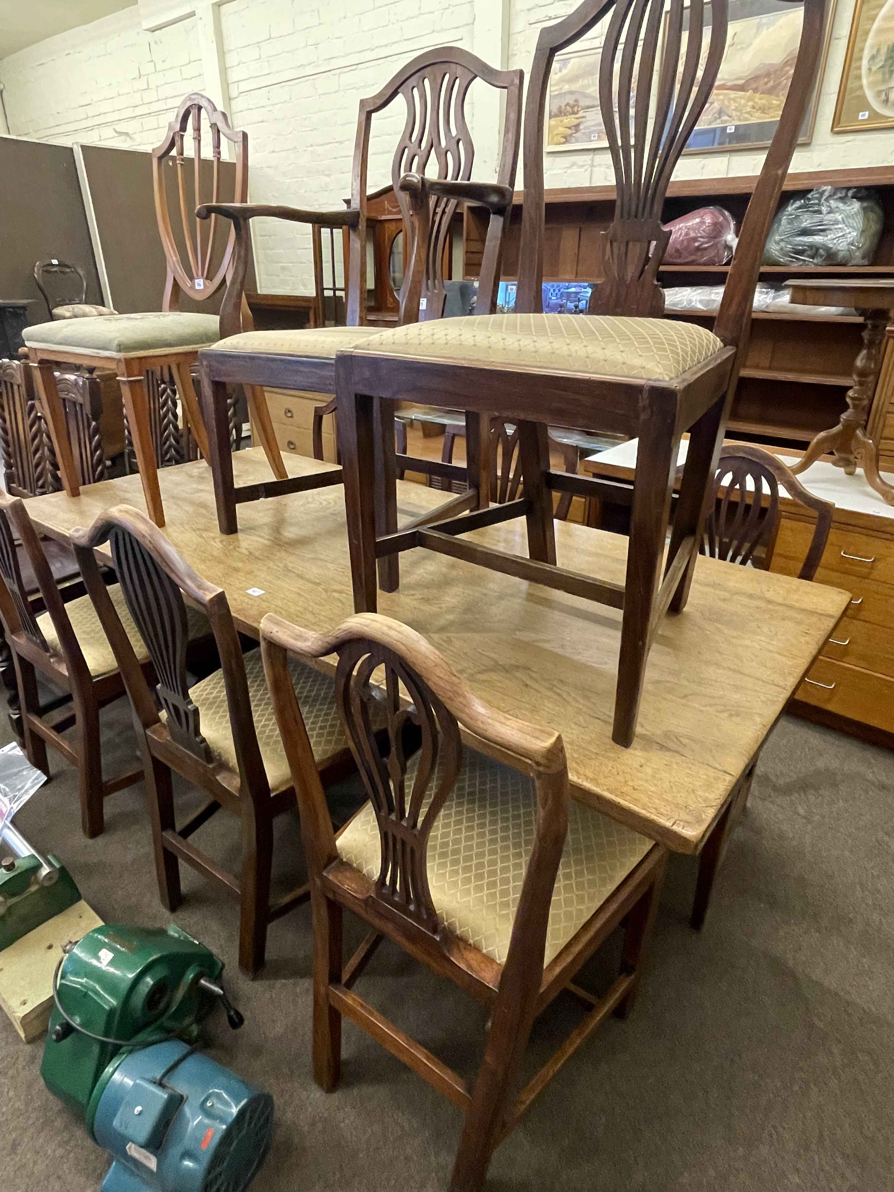 Oak refectory style dining table and eight various Georgian oak hepplewhite style dining chairs.