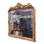 Large gilt framed bevelled overmantel mirror with foliate and winged cherub crest, 156cm by 139cm.