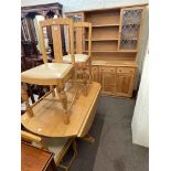 Light oak glazed door topped dresser, drop leaf dining table and four chairs.