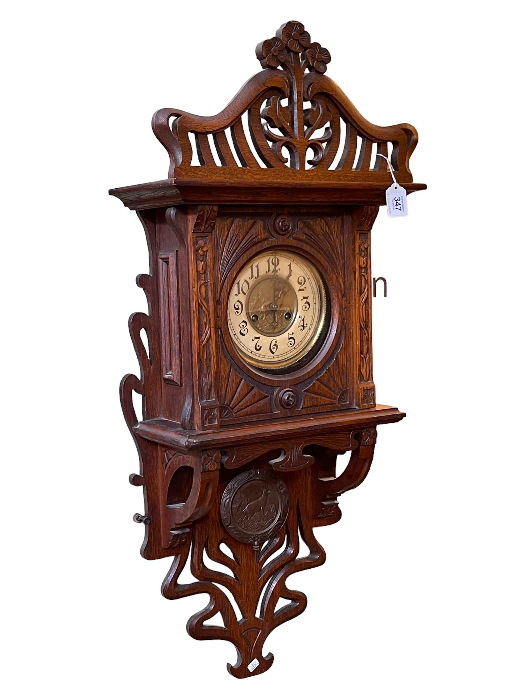 Art Nouveau oak cased wall clock having brass and enamelled dial.